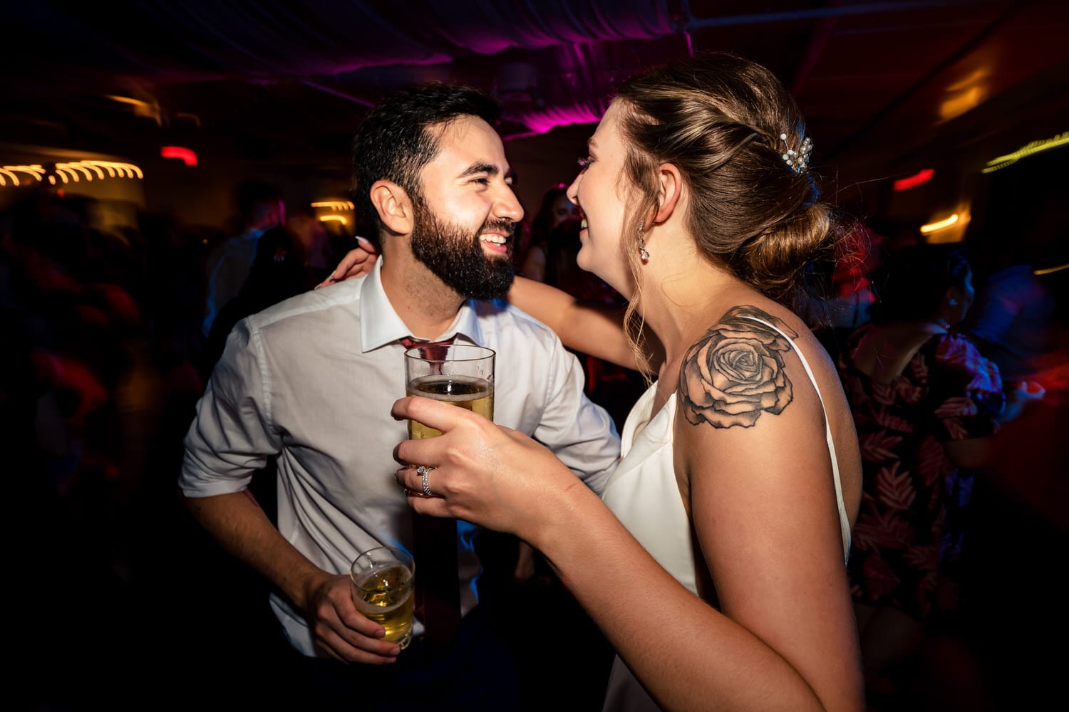 A colorful, candid picture of wedding guests dancing on the dance floor during a classic Kansas City wedding reception at Grand Street Cafe. 