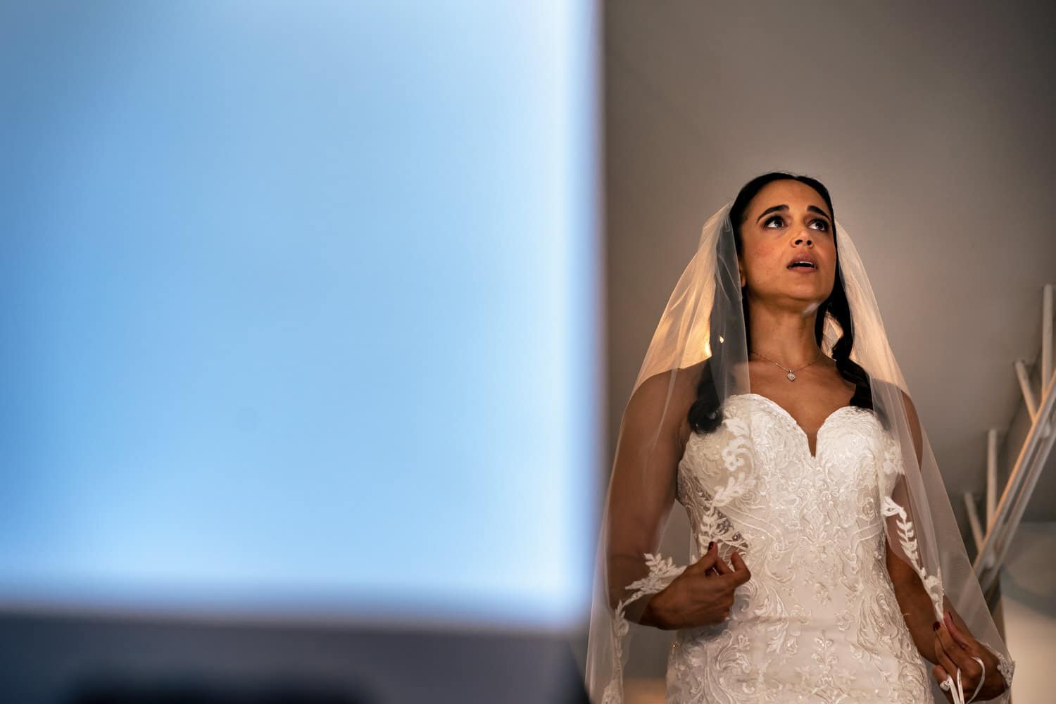 A candid picture of a bride taking a deep breath moments before walking down the aisle at The Station in Kansas City on her summer wedding day. 