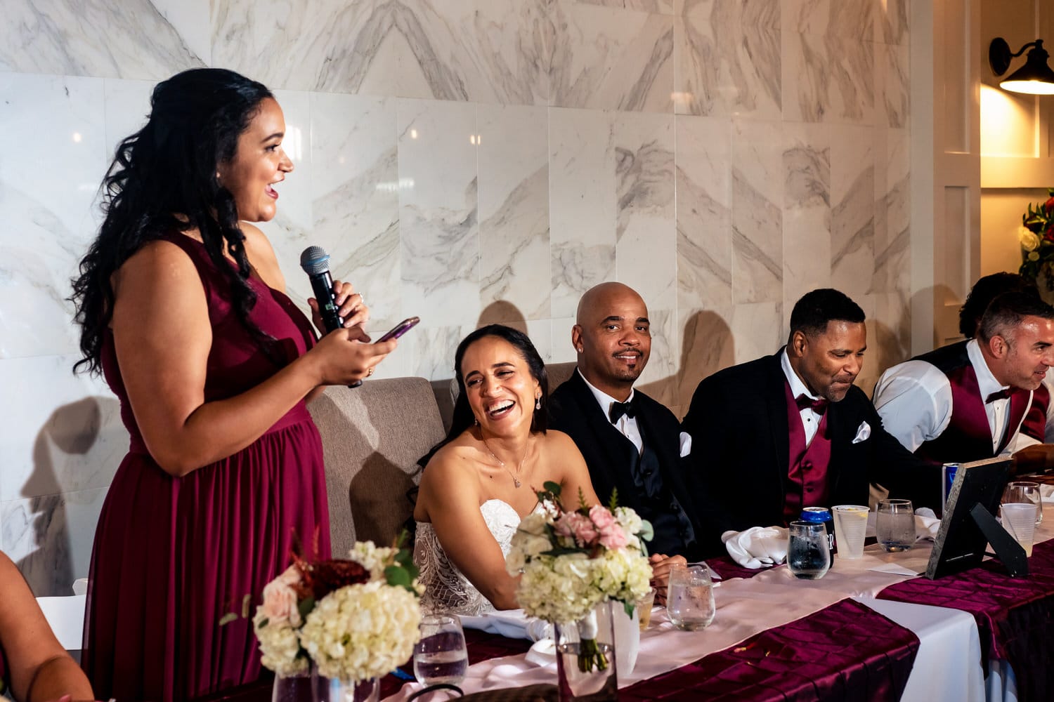 A candid picture of a bridesmaid giving a toast during a wedding reception at The Station in Kansas City. 