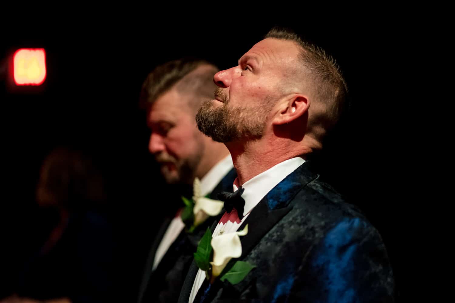 A candid picture of a groom taking a deep breath and looking up as he waits for his wedding ceremony at The Madrid Theatre to start. 