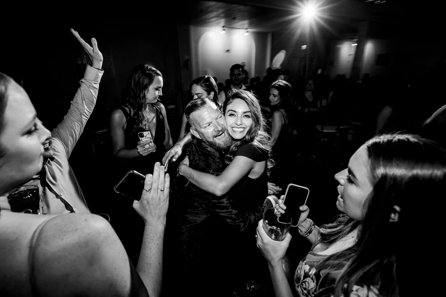 A candid picture of wedding guests dancing on the dance floor during a fall wedding reception at The Madrid Theatre in Kansas City. 